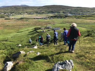 A group of people hiking down the hill